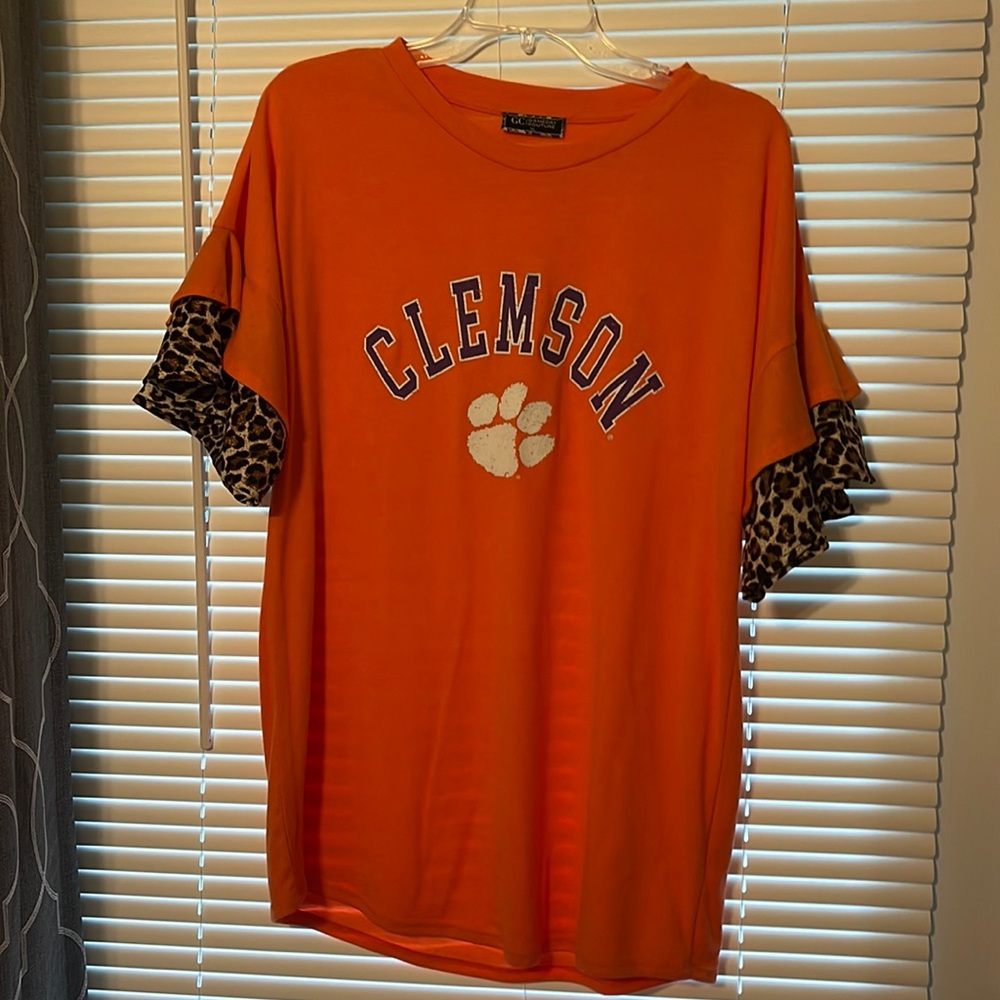 Game day Couture, orange with leopard print sleeves. Size XL